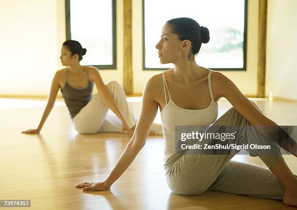 yoga class, - spinal twist stock pictures, royalty-free photos & images