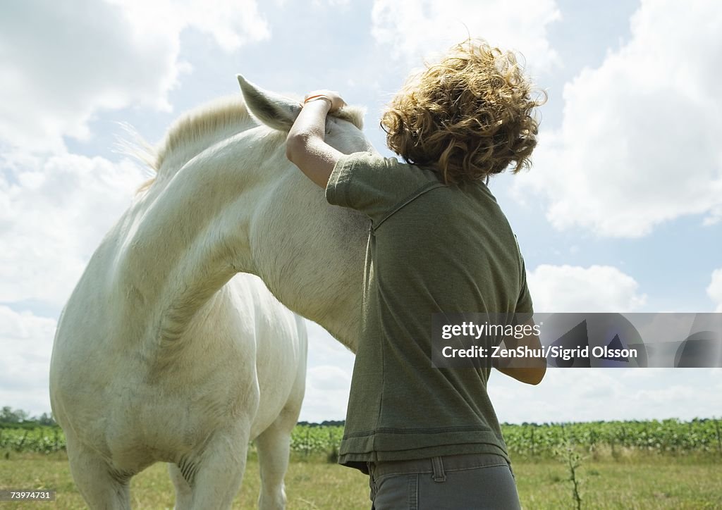 Boy petting horse