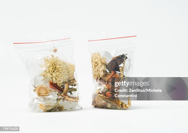 baggies containing chinese herbal tea mixture - herbal tea bag stock pictures, royalty-free photos & images