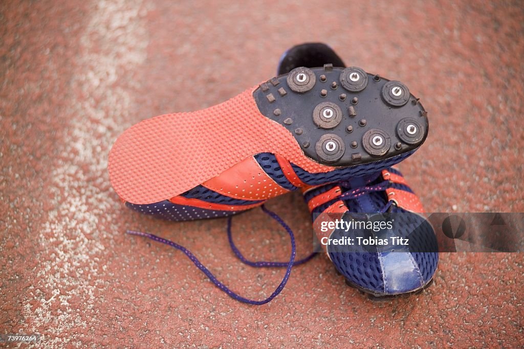Pair of running spikes on a running track