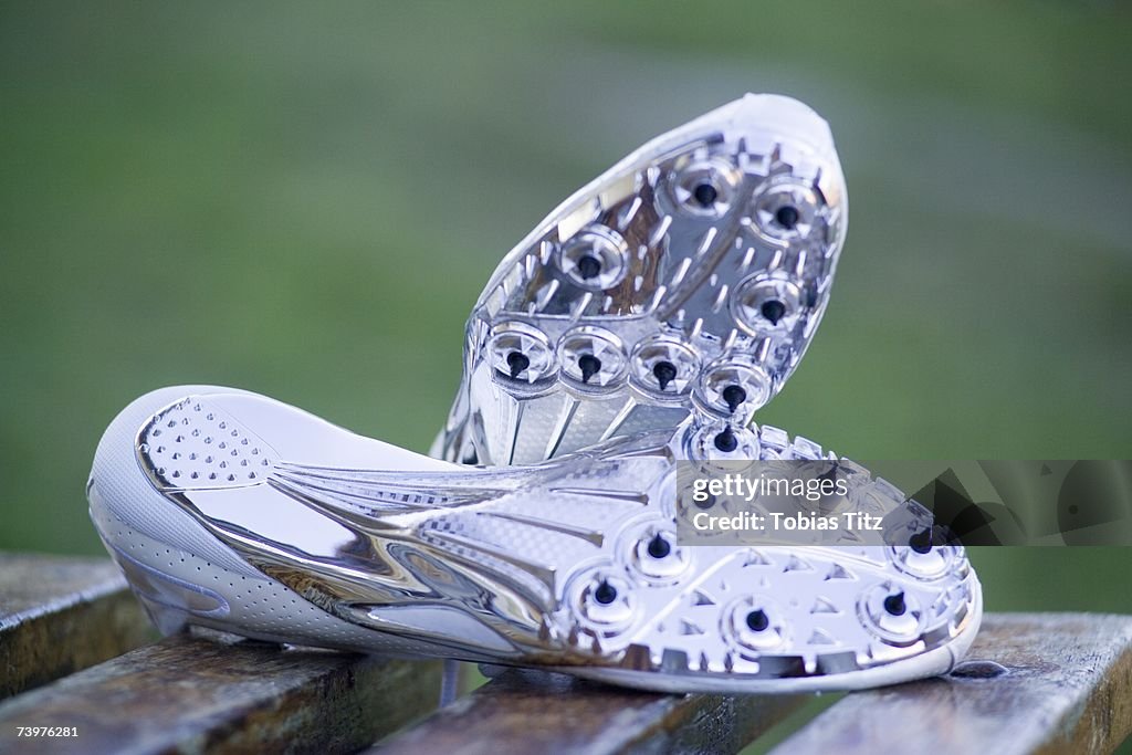 Pair of running spikes on a bench