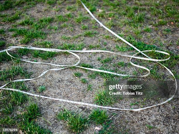tape measure unraveled on the ground - unraveled string stock pictures, royalty-free photos & images