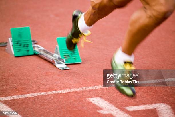 man running from starting blocks - track starting block stock pictures, royalty-free photos & images