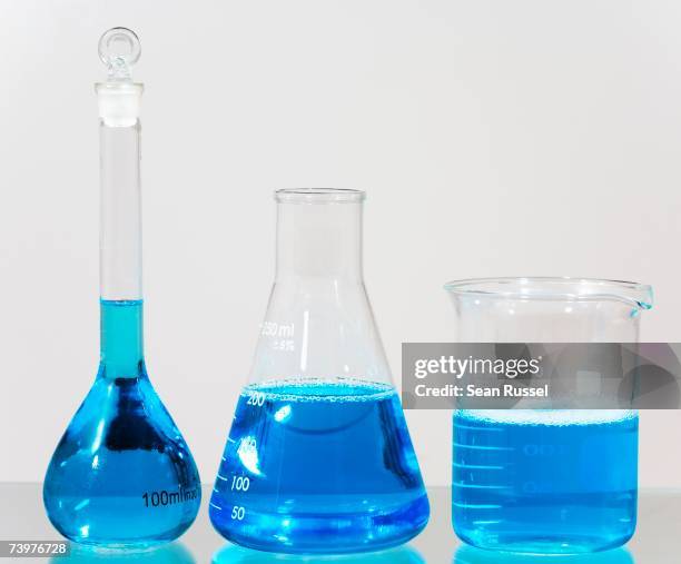 blue solution in assorted laboratory glassware - conical flask stock pictures, royalty-free photos & images
