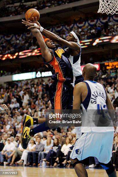 Al Harrington of the Golden State Warriors is fouled by Josh Howard of the Dallas Mavericks in Game Two of the Western Conference Quarterfinals...