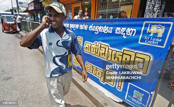 Sri Lankan man sporting a T-shirt similar to those worn by the national cricket players, walks in Sri Lanka's commercial hub of Fort, 26 April 2007...