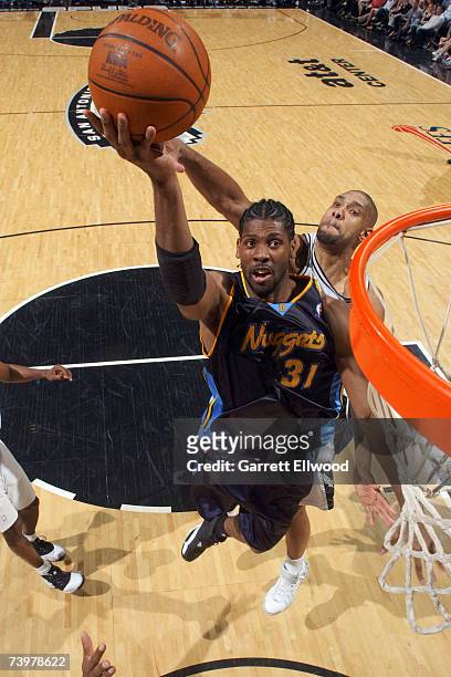 Nene the Denver Nuggets goes to the basket against Tim Duncan of the San Antonio Spurs in Game Two of the Western Conference Quarterfinals during the...