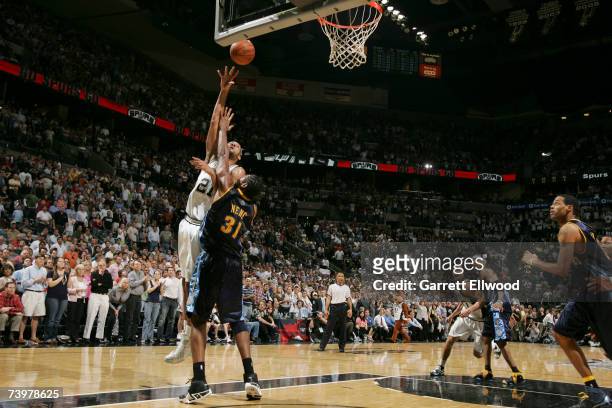 Tim Duncan of the San Antonio Spurs goes to the basket against Nene of the Denver Nuggets in Game Two of the Western Conference Quarterfinals during...