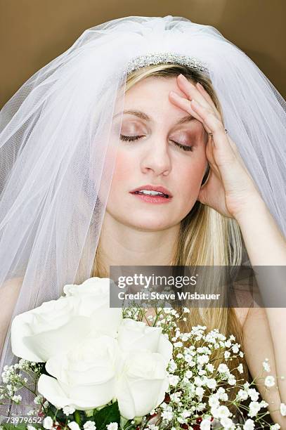 young woman wearing wedding veil, hand on forehead - nervous bride stock pictures, royalty-free photos & images