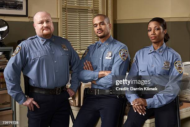 three police officers in office, portrait - police uniform stockfoto's en -beelden