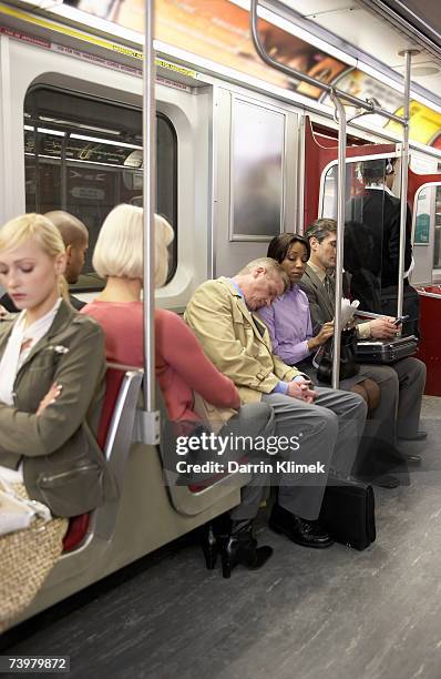 people in subway train, man resting head on woman's shoulder - 50 metros 個照片及圖片檔