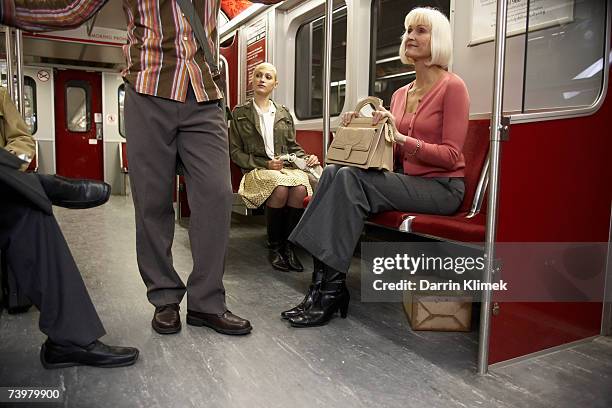 people in subway train, suspicious package hidden under seat - suspicious package stock pictures, royalty-free photos & images