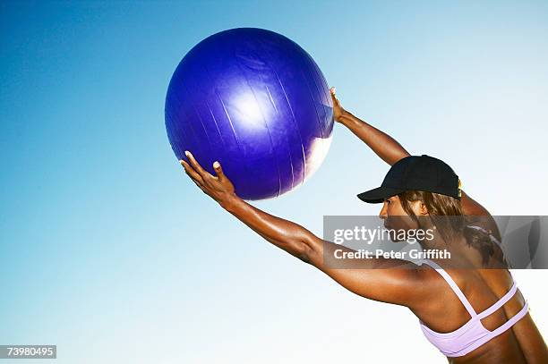 woman stretching with exercise ball, top section, rear view - yoga ball outside stock pictures, royalty-free photos & images