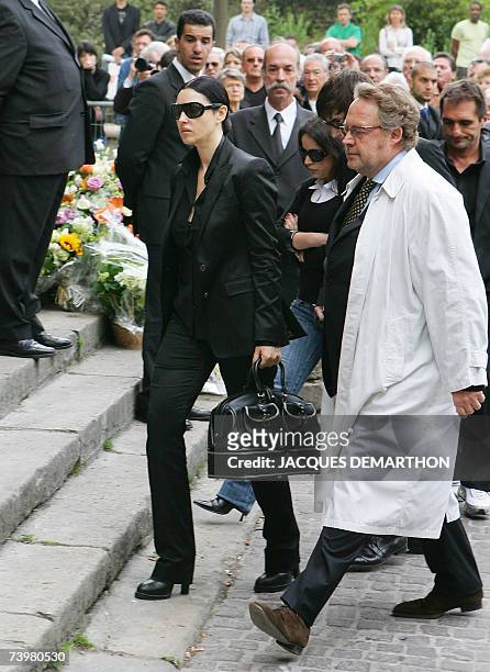 Italian actress Monica Bellucci arrives with press officer Dominique Segall at Saint-Eustache's church for a funeral mass for French actor...