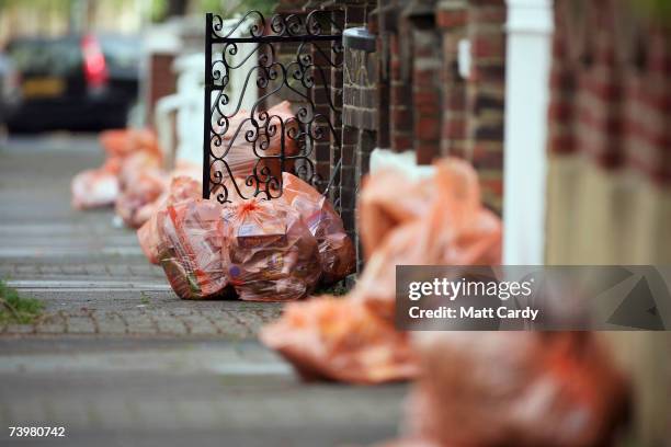 Bags of rubbish await collection on a domestic street in Clapham on April 26 2007 in London. Many councils in the UK are considering introducting...