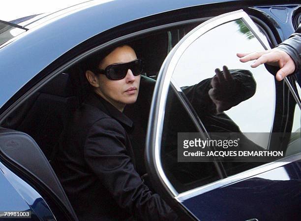 French actor Vincent Cassel's hand closes the door of the car for his companion Italian actress Monica Bellucci, as he leaves Saint-Eustache's church...
