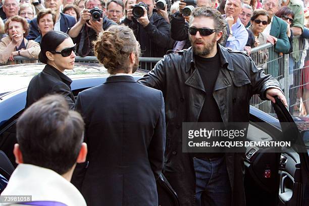 French actor Vincent Cassel , flanked by his companion Italian actress Monica Bellucci , leaves Saint-Eustache's church after the funeral mass of his...