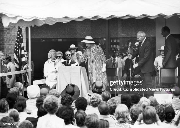 Queen Elizabeth pushes a button to electronically ring the new Liberty Bell in Philadelphia during her Bicentennial visit to the United States, 6th...