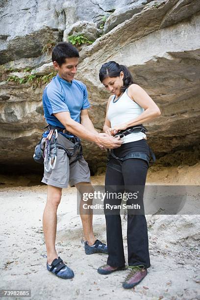 couple preparing to rock climb - chalk bag stock-fotos und bilder