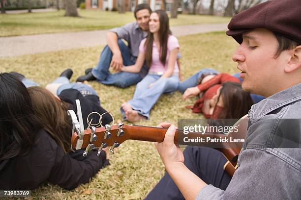 young man singing to friends on campus - long sideburns stock pictures, royalty-free photos & images