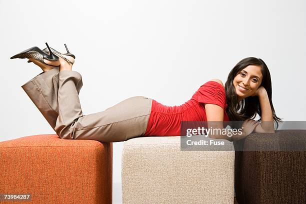 woman lying down on cubes - khaki fotografías e imágenes de stock