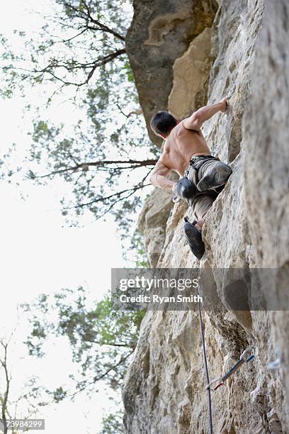 man rock climbing - chalk bag stock-fotos und bilder