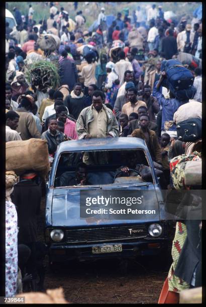 An unidentified Rwandan man rides in the back of a truck April 30, 1994 as it makes its way through the crowd in Tanzania. Two hundred fifty thousand...