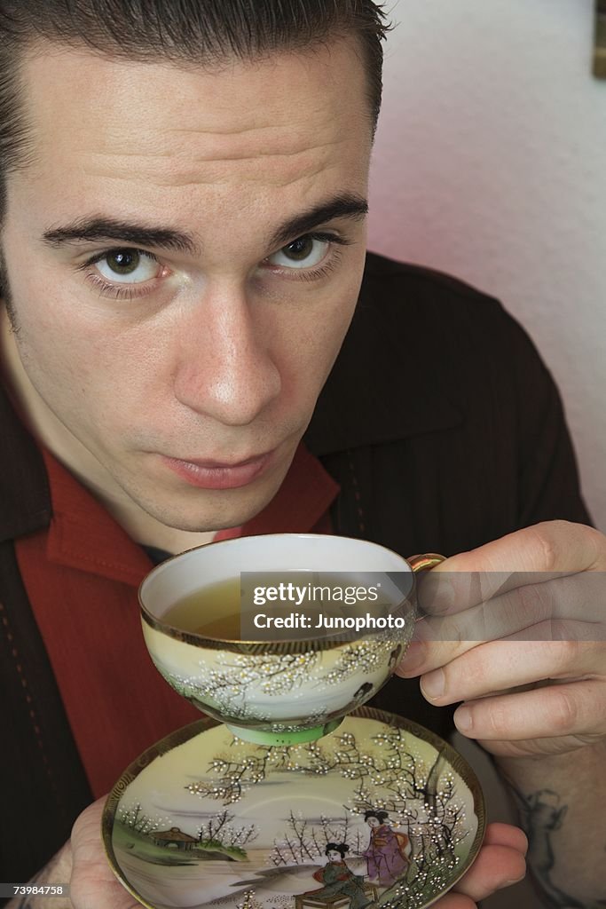 Young rockabilly man drinking tea