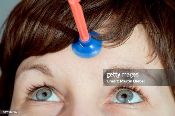 rubber dart stuck to woman's forehead - human eye stock pictures, royalty-free photos & images