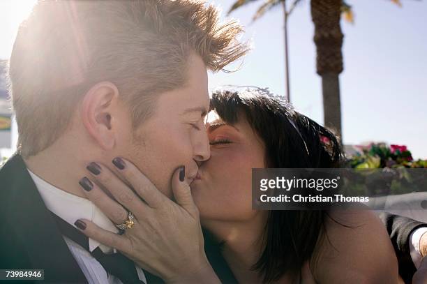 bride and groom kissing in the back seat of a convertible car - las vegas wedding ストックフォトと画像