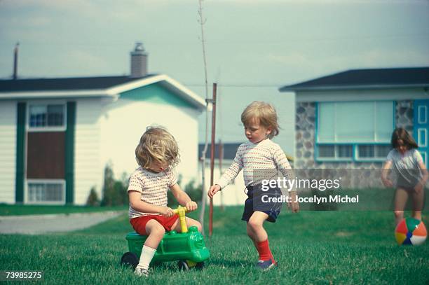 children playing in their front yard - memorial garden stock pictures, royalty-free photos & images