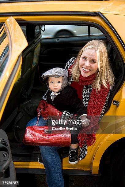 mother and child getting out of a yellow cab - taxi boys stock pictures, royalty-free photos & images