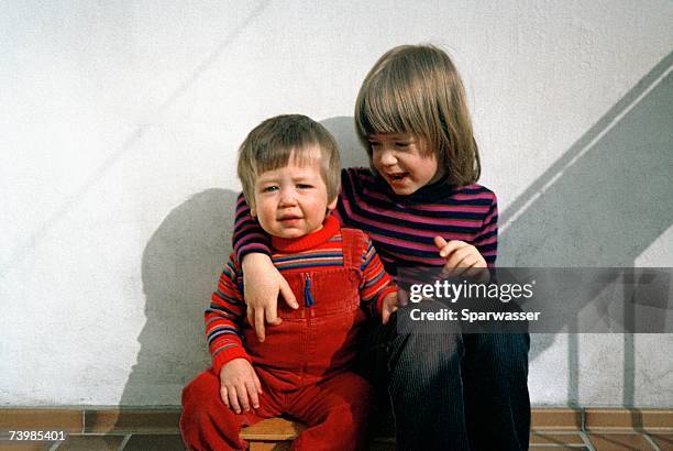two children sitting together - sibling support stock pictures, royalty-free photos & images