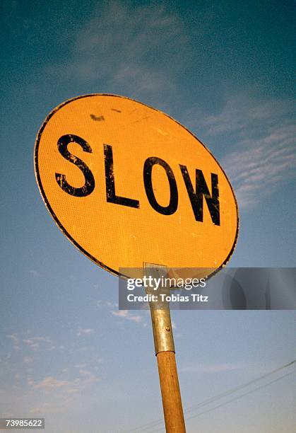 slow road sign - lentezza foto e immagini stock