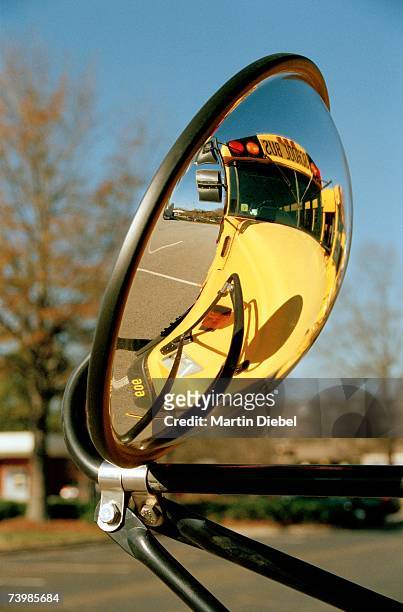 view of school bus in rear-view mirror - konvex stock-fotos und bilder