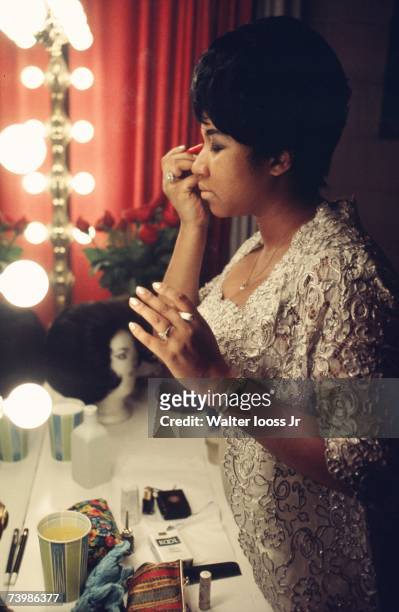Singer Aretha Franklin fixes her makeup backstage before a performance at Symphony Hall in 1969, Newark, New Jersey.