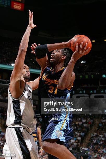 Nene of the Denver Nuggets goes to the basket against Tim Duncan of the San Antonio Spurs in Game Two of the Western Conference Quarterfinals during...