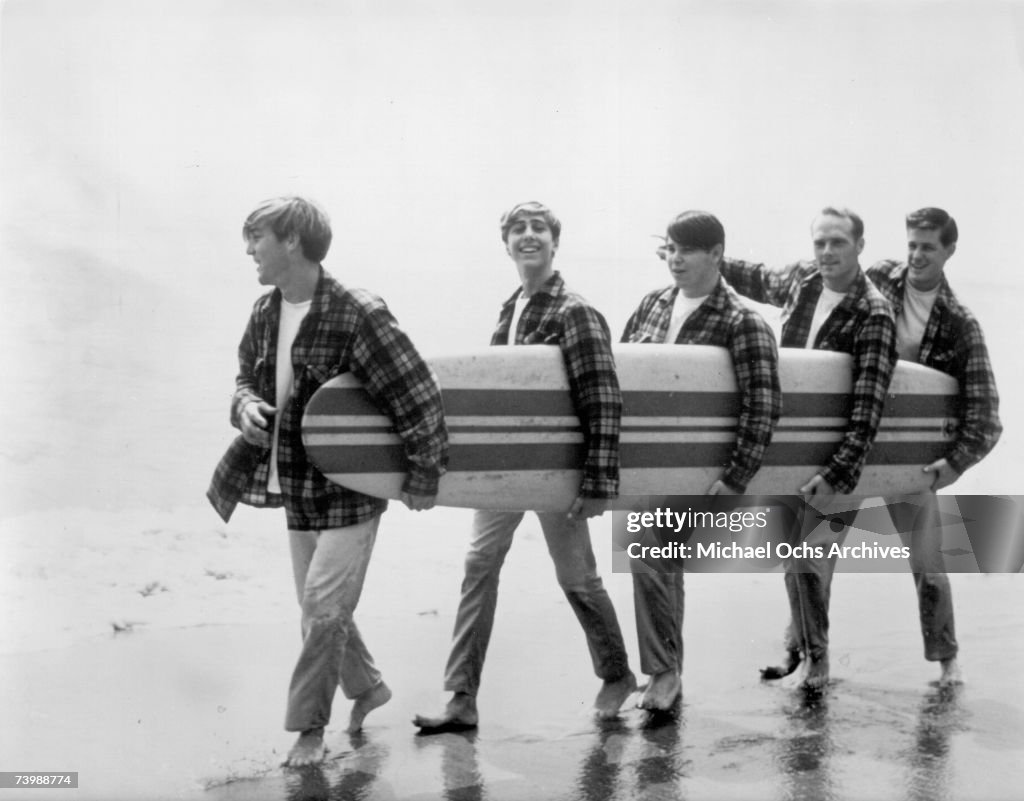 Beach Boys On The Beach With A Surfboard