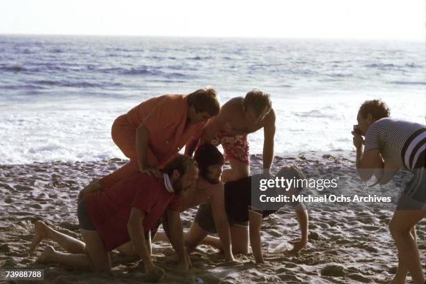 Rock and roll band "The Beach Boys" make a human pyramid in July 1967 in Los Angeles, California. Clockwise from top left: Dennis Wilson, Al Jardine,...