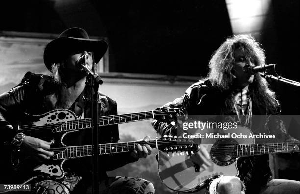 Singer Jon Bon Jovi and guitarist Richie Sambora of the hard rock group "Bon Jovi" play acoustic guitar as they performs their hit song "Wanted Dead...