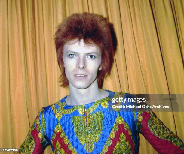 Rock and roll musician David Bowie poses for a portrait dressed as 'Ziggy Stardust' in a hotel room in 1973 in New York City, New York.