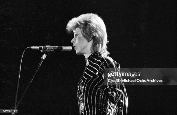 Musician David Bowie performs onstage during his "Ziggy Stardust" era in 1973 in Los Angeles, California.