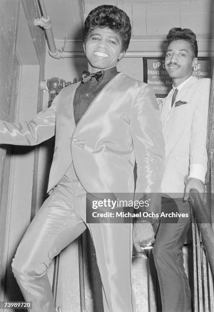 "Godfather of Soul" James Brown backstage at the Apollo Theatre with his cape man Danny Ray in 1964 in New York, New York.