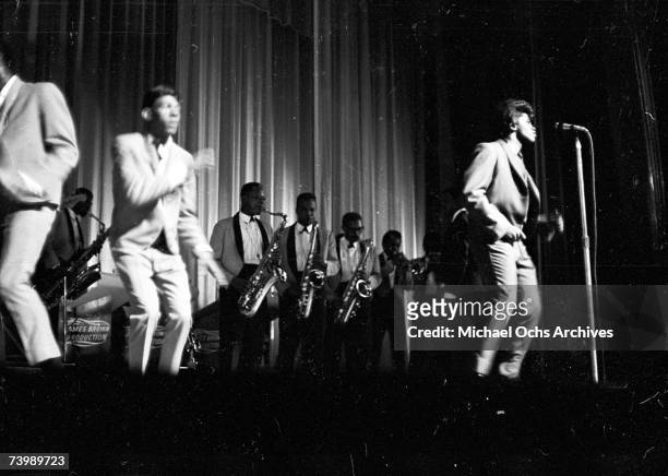 "Godfather of Soul" James Brown performs with The Famous Flames at the Apollo Theater in 1964 in New York, New York.