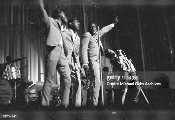 Soul singer James Brown performs onstage with Johnny Terry, Bobby Byrd and Bobby Bennett of the Famous Flames at the Apollo Theatre in New York, New...