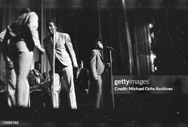 "Godfather of Soul" James Brown performs with The Famous Flames at the Apollo Theater in 1964 in New York, New York.