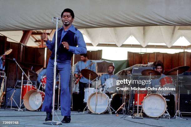 "Godfather of Soul" James Brown performs with 3 drummers at the Newport Folk Festival on July 6, 1969 in Newport, Rhode Island. The license plate...