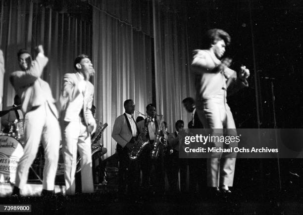 "Godfather of Soul" James Brown performs with The Famous Flames at the Apollo Theater in 1964 in New York, New York.