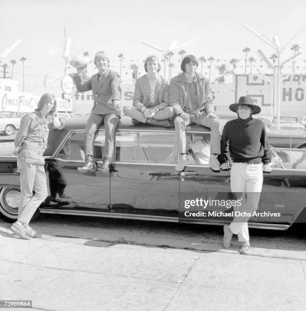 Superstar group "Buffalo Springfield" pose for a portrait sitting on a car in 1966 in Los Angeles, California. Bruce Palmer, Dewey Martin, Stephen...