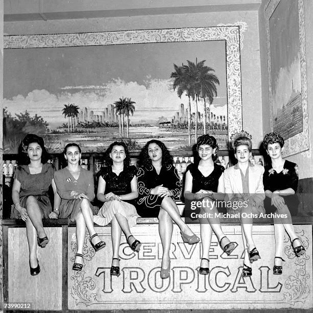 Girls sit on the bar at a nightclub in 1946 in Havana, Cuba.